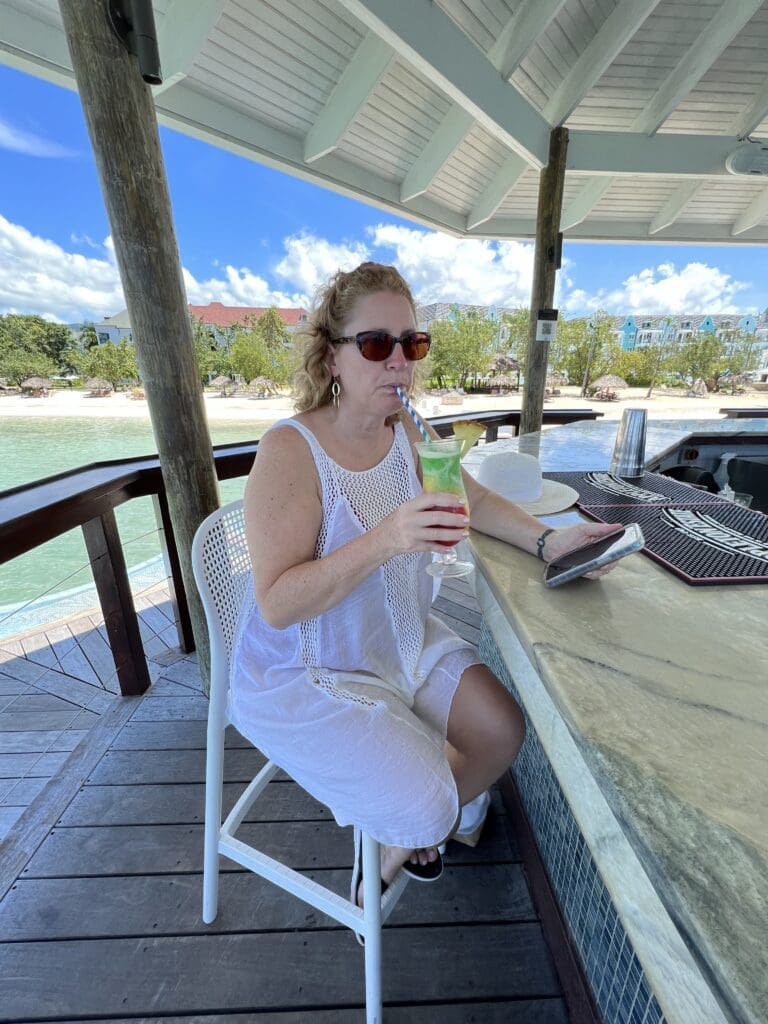Jo'El at the over-the-water bar during our Sandals South Coast resort visit. How we evaluate Sandals and Beaches Resorts